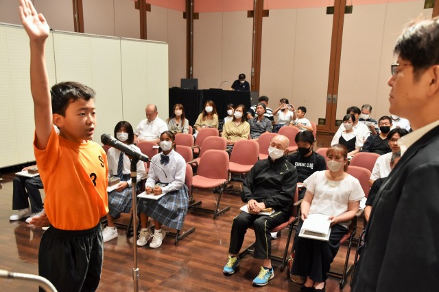 力強く選手宣誓する内野さん（左）＝下田市民文化会館