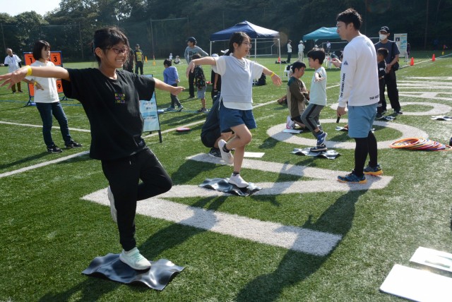 走りに必要な体の土台を鍛える参加者ら＝熱海市の姫の沢公園スポーツ広場