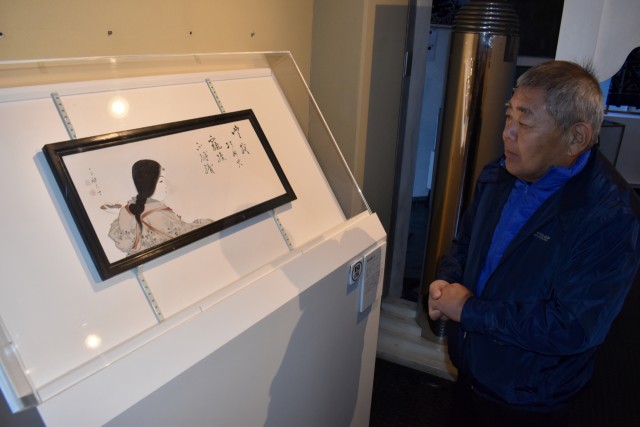 新たに展示作品に加わった「機を織る女」を観察する来館者＝松崎町の伊豆の長八美術館