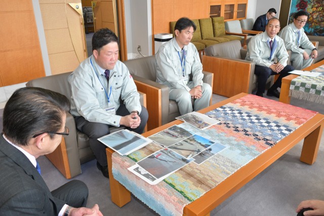 小野市長（左）に七尾市での活動を報告する市職員たち＝伊東市役所